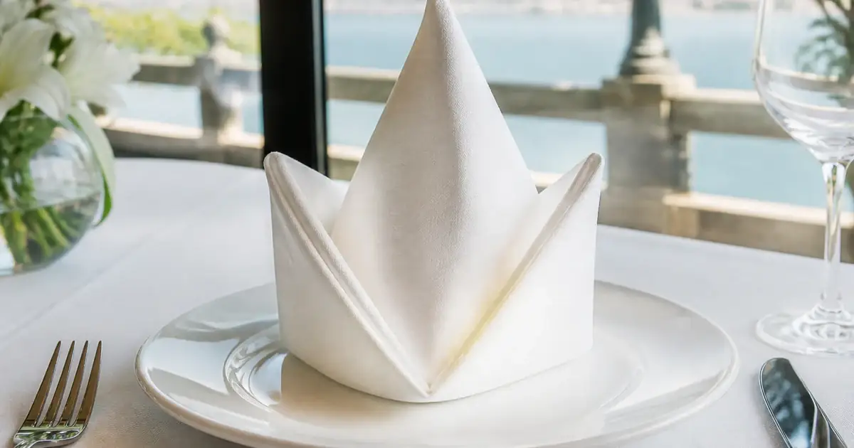 Folded white napkin on a restaurant plate