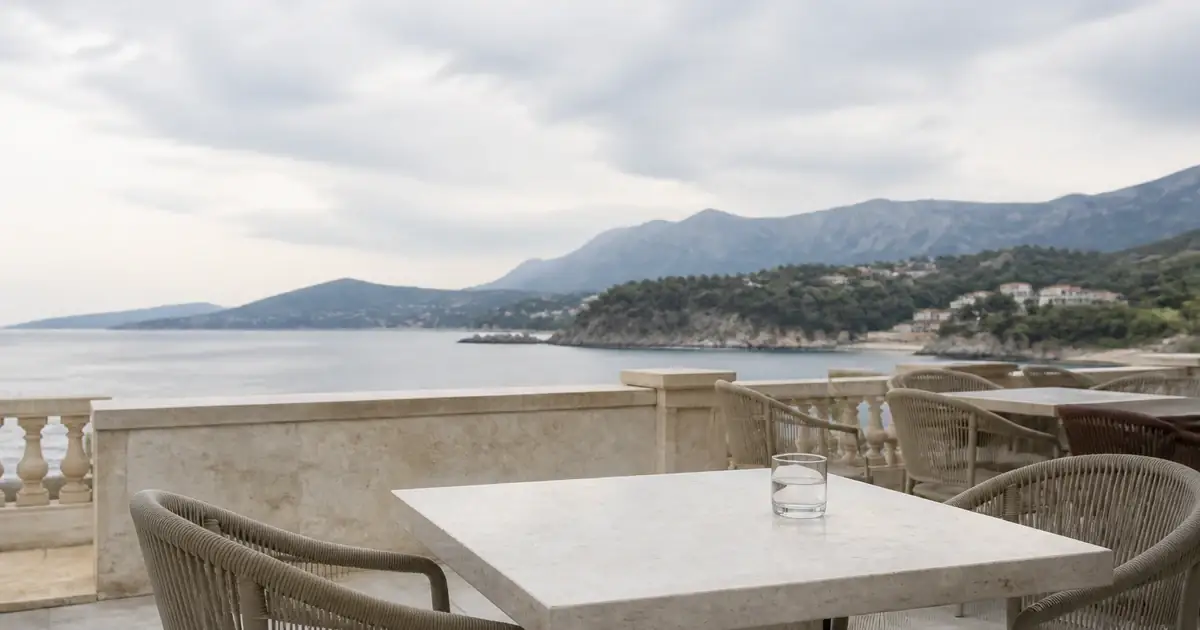 Empty terrace table on pale stone in overcast light